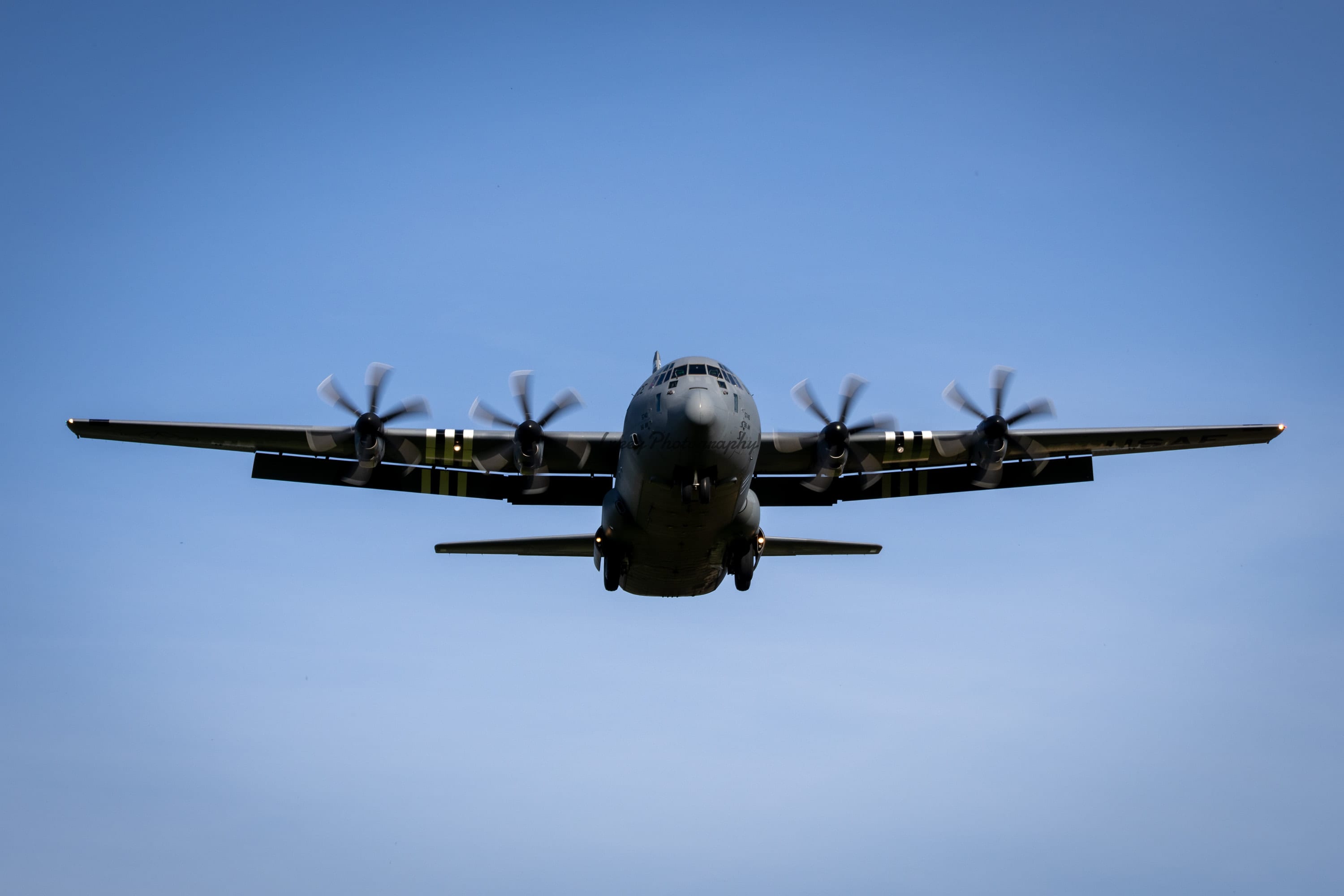 USAF 37th Airlift Squadron C-130J-30 Super Hercules with D-Day invasion stripes approaching RAF Fairford head-on
