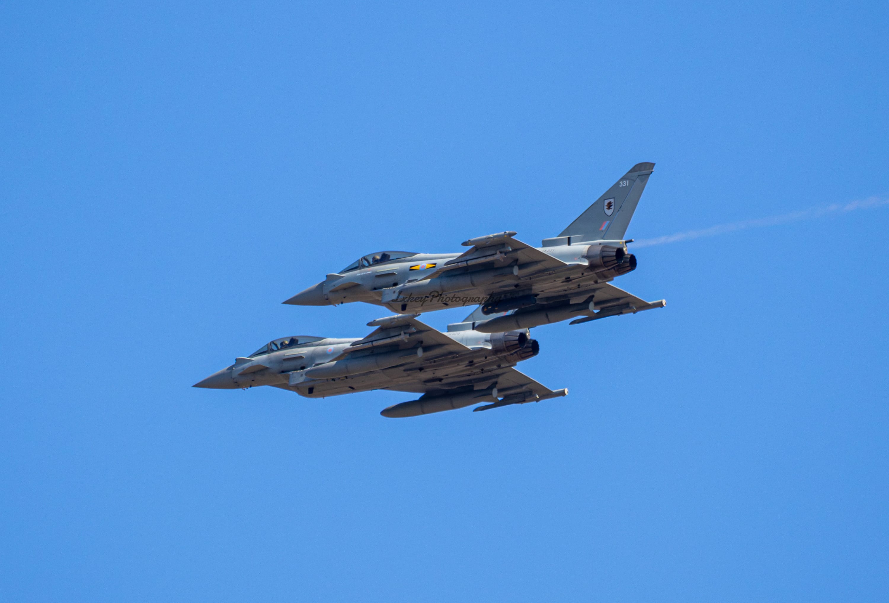 Pair of Royal Air Force Eurofighter Typhoons in close formation led by 12 Squadron aircraft ZK331